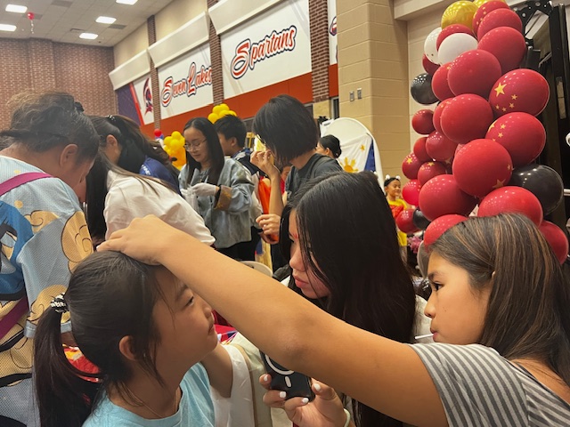 Paint Away Hunger members providing face painting at Seven Lakes Junior High School International Festival